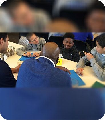 A group of people sitting around a table.