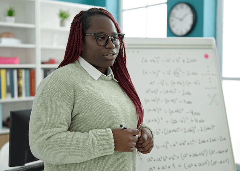 Person teaching math in a classroom setting.