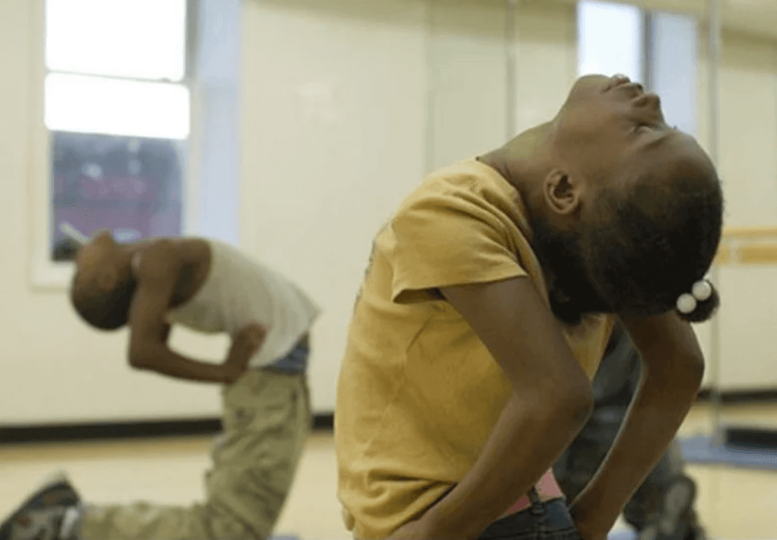 a little kid bending backward