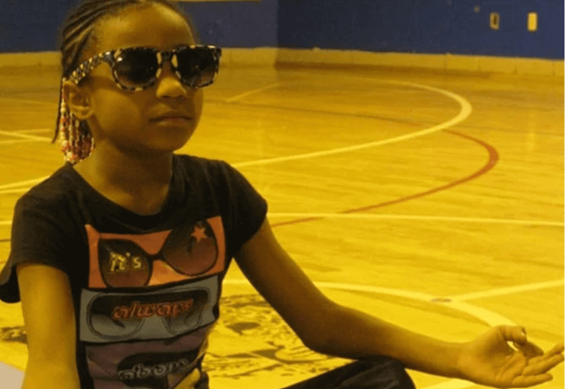 closeup shot of a little girl meditating