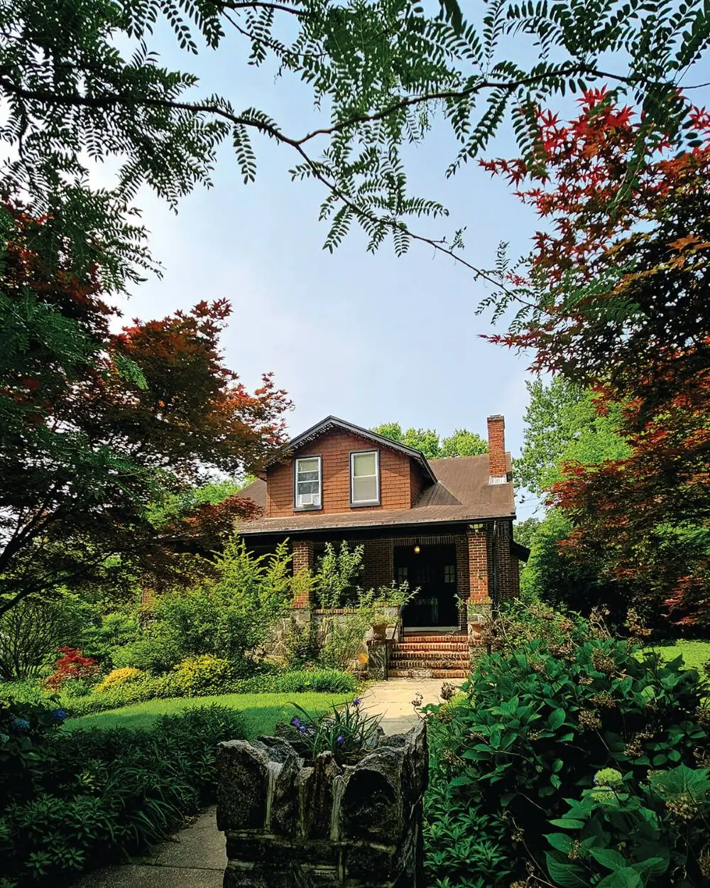 Charming brick house with a lush garden in summer